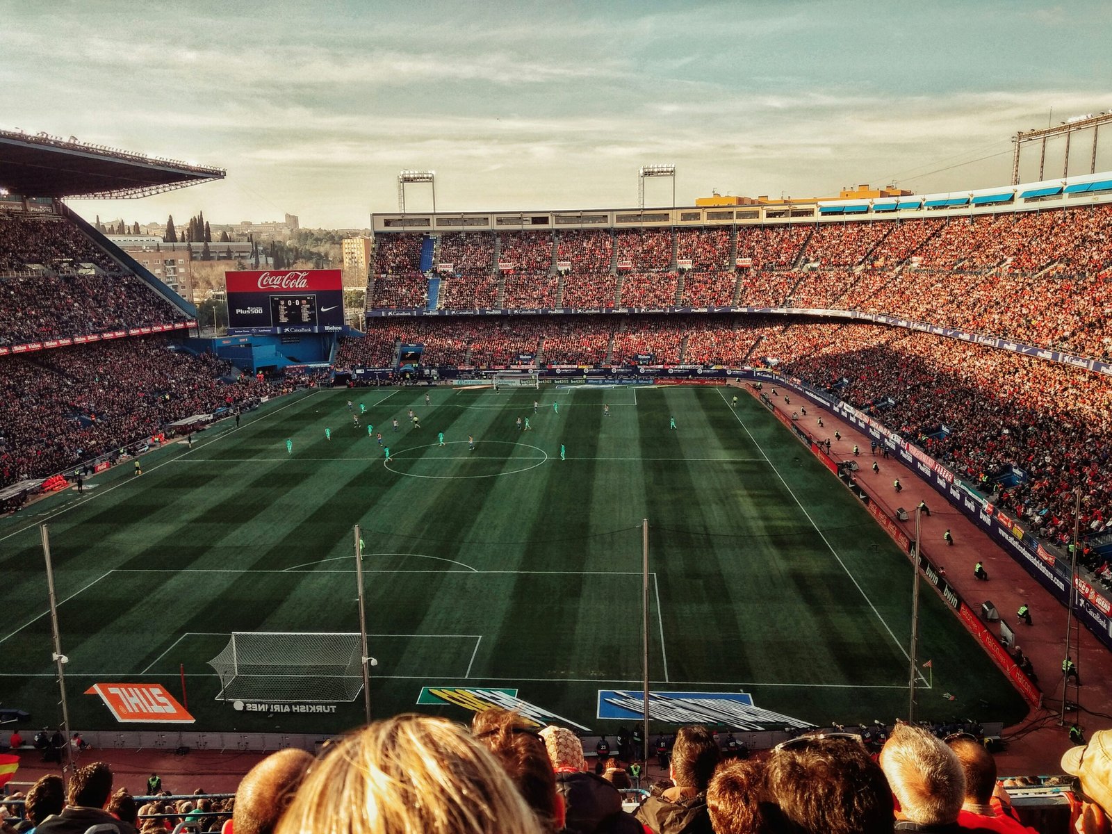 green soccer field with crowd at daytime